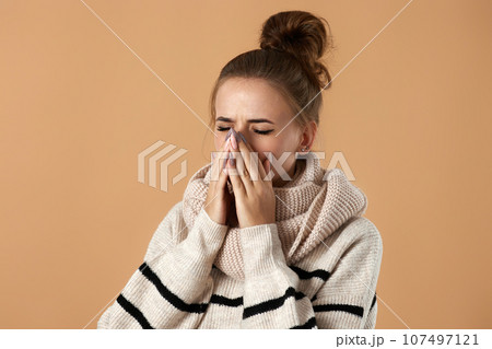woman in sweater suffering from fever and flu 107497121