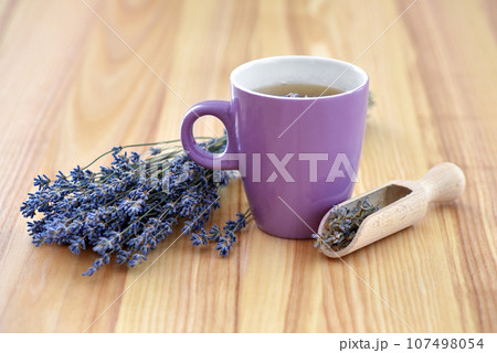 Cup of tea and lavender flowers on a wooden table Cup of tea and lavender flowers on a wooden table 107498054