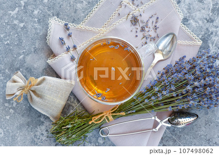 Bunch of lavender flowers, sachet filled with dried lavender and healthy tea. Top view. Flat lay. Bunch of lavender flowers, sachet filled with dried lavender and healthy tea. Top view. Flat lay. 107498062