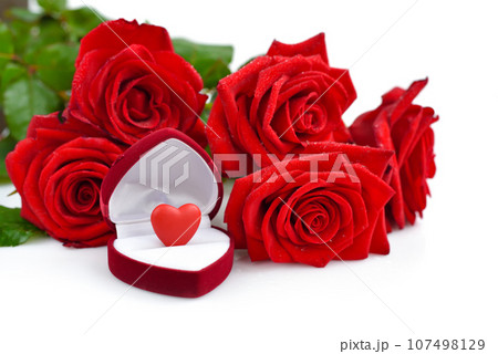 Red rose bouquet with open gift box with heart on a white background. Valentines Day concept. 107498129