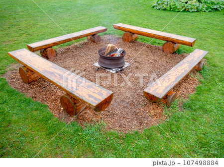 Camp fire under the rain 107498884