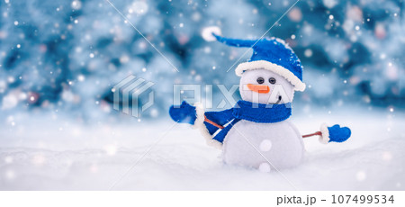 Little handmade snowman on the white snow on blue background. Little handmade snowman on the white snow on blue background. 107499534