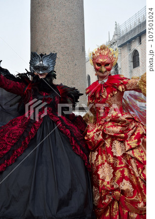 Couple of people dressed up for the Venice Carnival 107501024