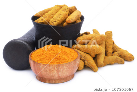 Whole and ground turmeric with mortar and pestle 107501067