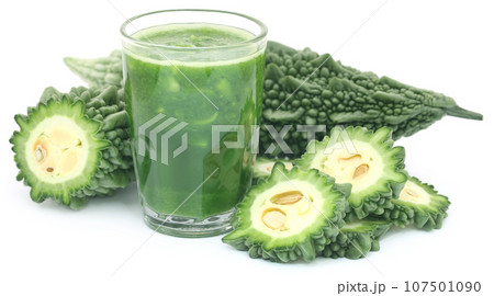 Green momodica with juice in a glass 107501090