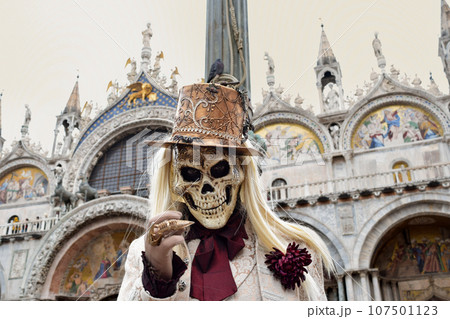 Person dressed up for Carnival of Venice wearing skull mask and white suit Person dressed up for Carnival of Venice wearing skull mask and white suit 107501123