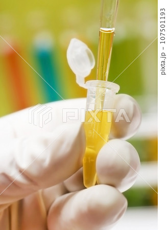Hand holding a plastic sample tube Hand holding a plastic sample tube 107501193