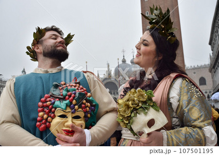 Couple of people dressed up for the Venice Carnival wearing Baco and Ariadna costumes Couple of people dressed up for the Venice Carnival wearing Baco and Ariadna costumes 107501195