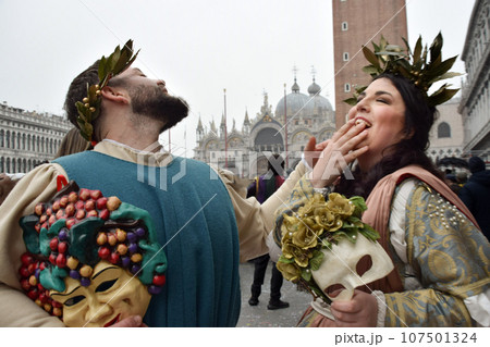 Couple of people dressed up for the Venice Carnival wearing Baco and Ariadna costumes 107501324