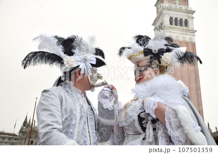 Couple of people dressed up for the Venice Carnival 107501359