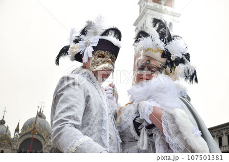 Couple of people dressed up for the Venice Carnival 107501381