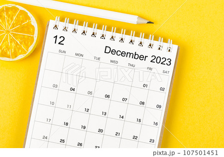 The October 2023 Monthly desk calendar for 2023 year with wooden pencil on yellow background. 107501451