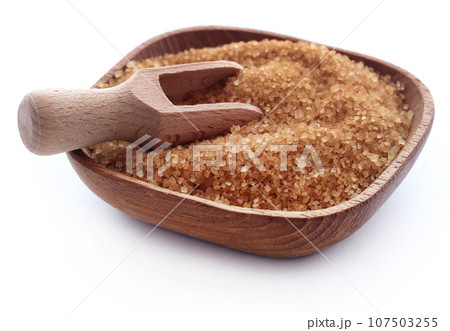 Brown sugar with wooden scoop Brown sugar with wooden scoop 107503255