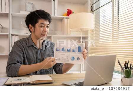 Man Working from Home, Video call with customers on laptop, Remote Business Communication, Telecommuting Professional, Virtual Video Call with Office Customer, Work from Home Concept. Man Working from Home, Video call with customers on laptop, Remote Business Communication, Telecommuting Professional, Virtual Video Call with Office Customer, Work from Home Concept. 107504912