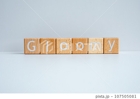 Wooden blocks form the text "Gloomy" against a white background. Wooden blocks form the text "Gloomy" against a white background. 107505081