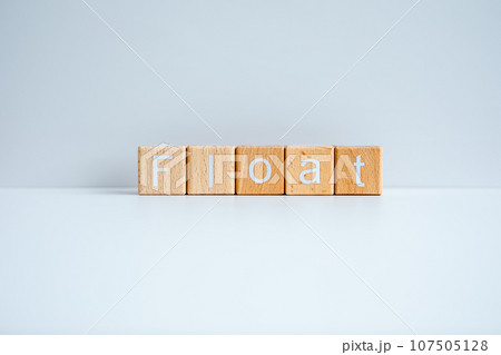 Wooden blocks form the text "Float" against a white background. Wooden blocks form the text "Float" against a white background. 107505128