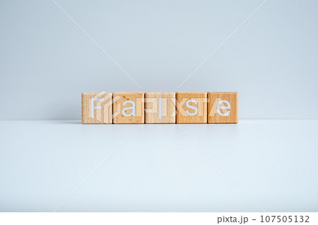 Wooden blocks form the text "False" against a white background. 107505132