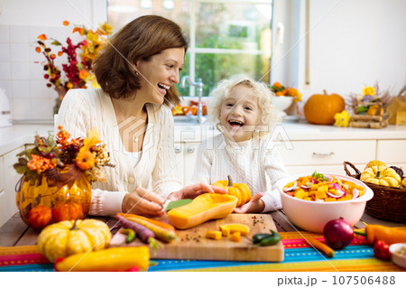 Family cooking pumpkin soup for Halloween lunch Family cooking pumpkin soup for Halloween lunch 107506488