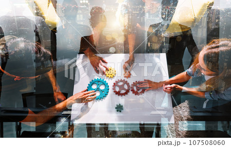 Business team work together and combine pieces of gears. Partnership and integration concept 107508060