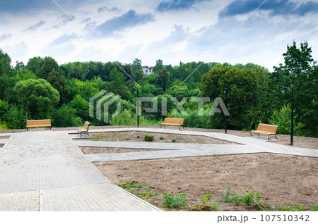 Europe, Russia.City landscape in summer, benches in the city park. Europe, Russia.City landscape in summer, benches in the city park. 107510342