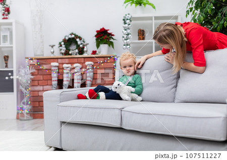 Mom tenderly strokes her baby son's little cheek Mom tenderly strokes her baby son's little cheek 107511227