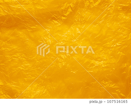 Orange Plastic Texture Wrap Overlay Yellow Background Effect Bag Sticker Foil Pattern Wrinkle Film Grunge Mockup Package Backdrop Scene Color Summer Clear Mockup Poster Glossy Wall Sheet Wrapping. 107516165