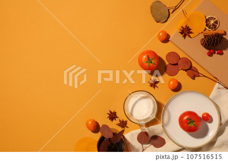Yellow background featured some types of spice, tomatoes and a glass cup of milk. Thanksgiving Day will be celebrated as a dinner party with family and friends Yellow background featured some types of spice, tomatoes and a glass cup of milk. Thanksgiving Day will be celebrated as a dinner party with family and friends 107516515