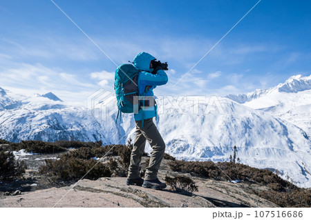 Woman hiker hiking in winter huge glacier mountain,China 107516686
