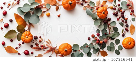 Thanksgiving day or Halloween concept banner. Top view white background decor from pumpkin, red berry, green leaves with copy space. autumn and fall season background. 107516941