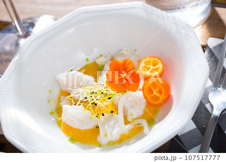 Ceviche from hake with spicy avocado sauce and cumquat at plate Ceviche from hake with spicy avocado sauce and cumquat at plate 107517777