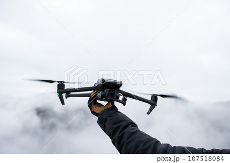 Flying drone in high altitude mountains 107518084