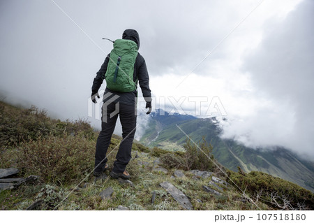 Hiking woman on high altitude mountain top 107518180
