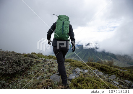 Hiking woman on high altitude mountain top Hiking woman on high altitude mountain top 107518181