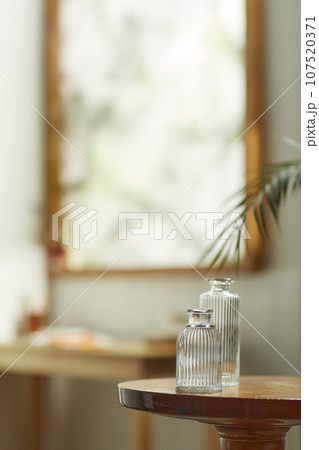 A comfortable room where warm afternoon sunlight comes in through a window with a view of tree leaves. A comfortable room where warm afternoon sunlight comes in through a window with a view of tree leaves. 107520371