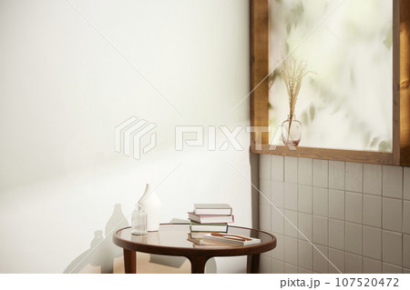 A comfortable room where warm afternoon sunlight comes in through a window with a view of tree leaves. 107520472
