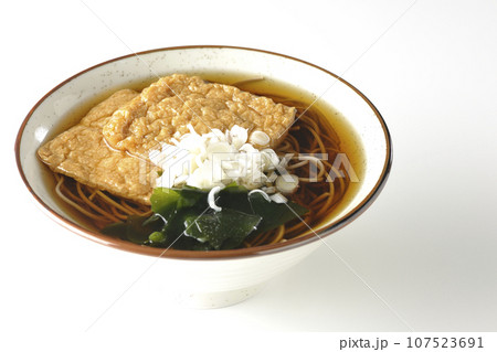 油揚げ2枚とワカメと葱が乗ったきつね蕎麦を白背景で撮影 油揚げ2枚とワカメと葱が乗ったきつね蕎麦を白背景で撮影 107523691
