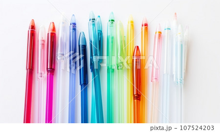 Colorful pens on white background. A set of colorful pens with clear body and colored cap, arranged in a diagonal line on a plain white background. The pens are in the colors pink, red, orange, yellow Colorful pens on white background. A set of colorful pens with clear body and colored cap, arranged in a diagonal line on a plain white background. The pens are in the colors pink, red, orange, yellow 107524203