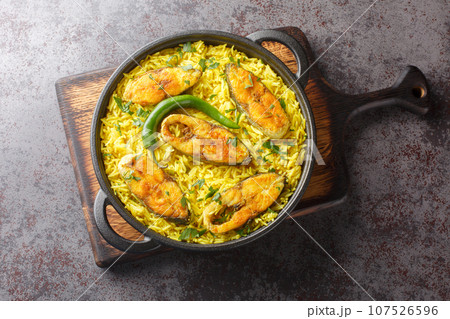 Bengali style Fish Pilaf cooked with Ilish Fish closeup on the black pan. Horizontal top view 107526596