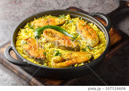 Fish pilaf Ilish Pulao cooked with Hilsa Fish closeup on the plate. Horizontal 107526606