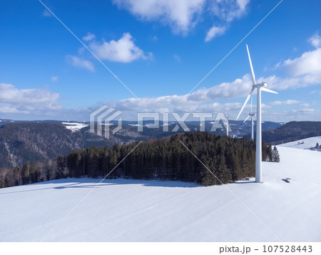 Black Forest with wind energy in snowy winter with space for your content Black Forest with wind energy in snowy winter with space for your content 107528443
