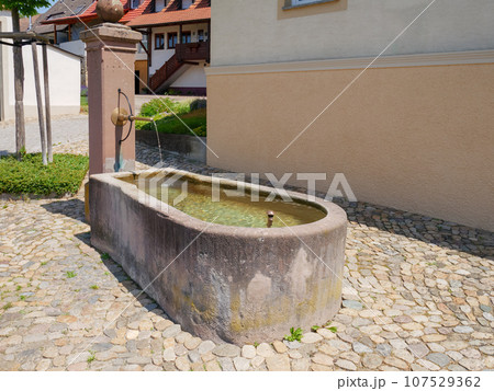 typical fountain at a south germany village 107529362