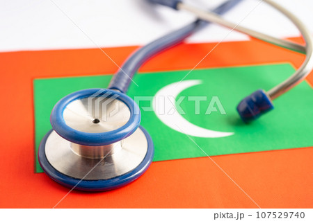 Stethoscope on Maldives flag background, Business and finance concept. Stethoscope on Maldives flag background, Business and finance concept. 107529740