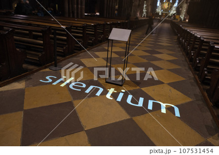 the word silentium projected on the floor of a church 107531454