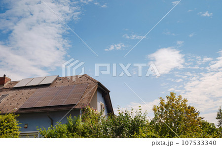 Solar photovoltaic panels on house roof. Modern country house with self-sustaining energy system. Suburb of Vienna, Austria. Idea harnessing clean and sustainable energy, saving money on electricity 107533340