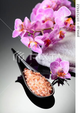 Beautiful blooming orchid flowers and pink sea salt. Beautiful blooming orchid flowers and pink sea salt. 107534922