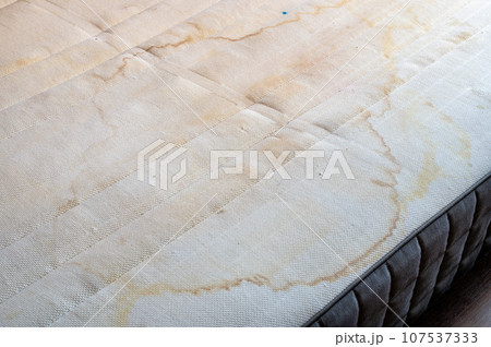 Stains and dirt on the mattress background. Close-up view on it 107537333