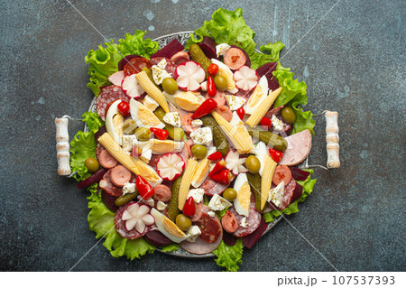 Fiambre, salad of Guatemala, Mexico and Latin America, served on large plate top view. Festive dish for All Saints Day (Day Of The Dead) celebration made of cold cuts, sausages, pickled vegetables Fiambre, salad of Guatemala, Mexico and Latin America, served on large plate top view. Festive dish for All Saints Day (Day Of The Dead) celebration made of cold cuts, sausages, pickled vegetables 107537393