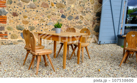 Wooden furniture . Cafe interior with wooden furniture. hearts carved into the chairs 107538600