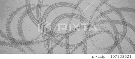 Loop-shaped round tire tracks on a gray road. 107538621