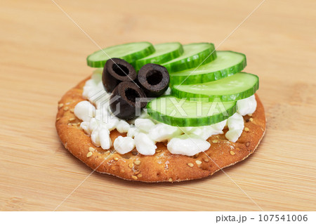 Crispy Cracker Sandwich with Fresh Cucumber, Cottage Cheese and Olives Crispy Cracker Sandwich with Fresh Cucumber, Cottage Cheese and Olives 107541006